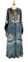 A Chinese embroidered silk blue ground dragon robe, late Qing Dynasty,