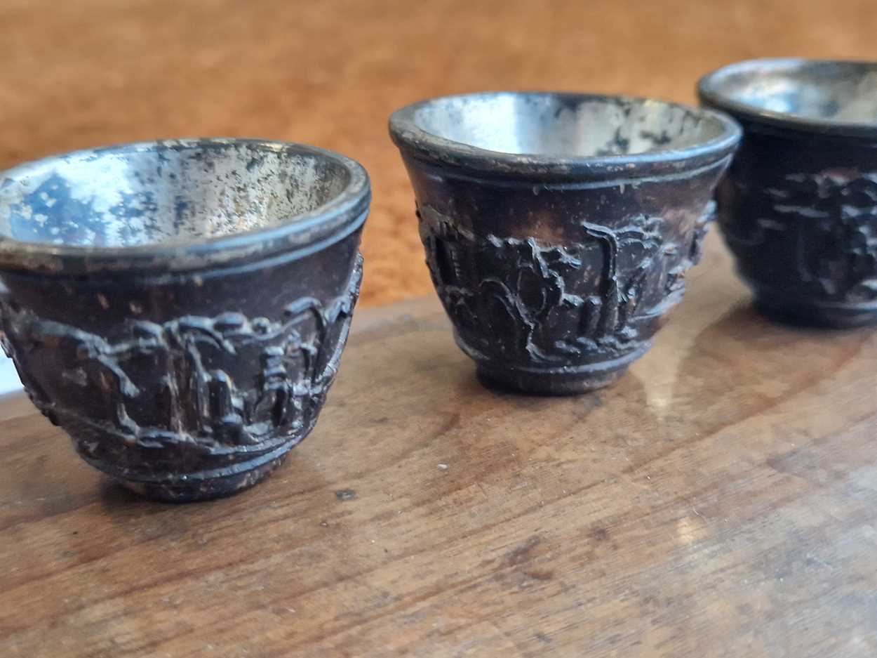 A set of eight Chinese export carved and silver mounted coconut wood wine cups, Qing Dynasty, early - Image 8 of 20