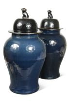 A pair of Chinese porcelain monochrome blue/black glazed baluster vases and covers, 20th century,