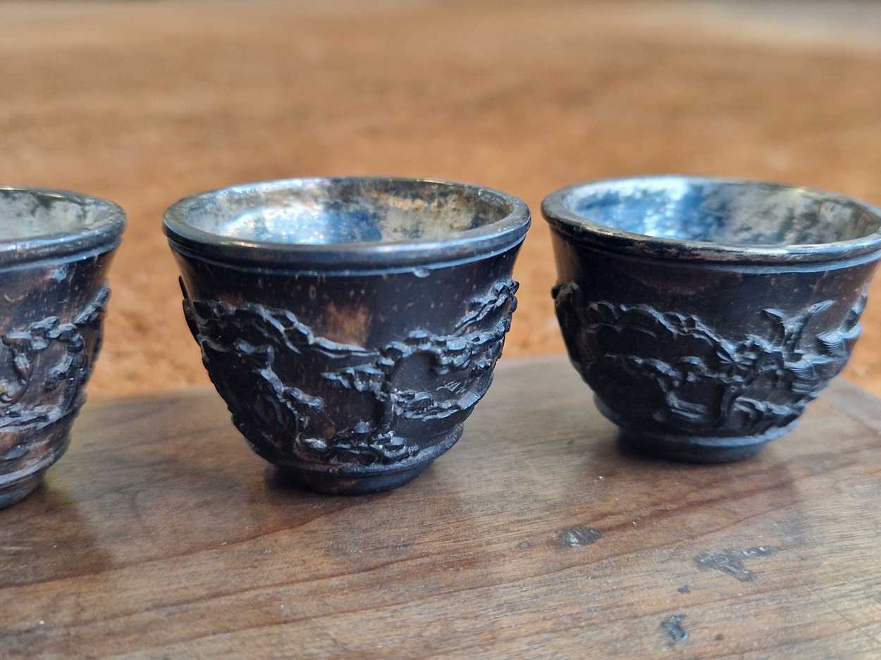 A set of eight Chinese export carved and silver mounted coconut wood wine cups, Qing Dynasty, early - Image 9 of 20