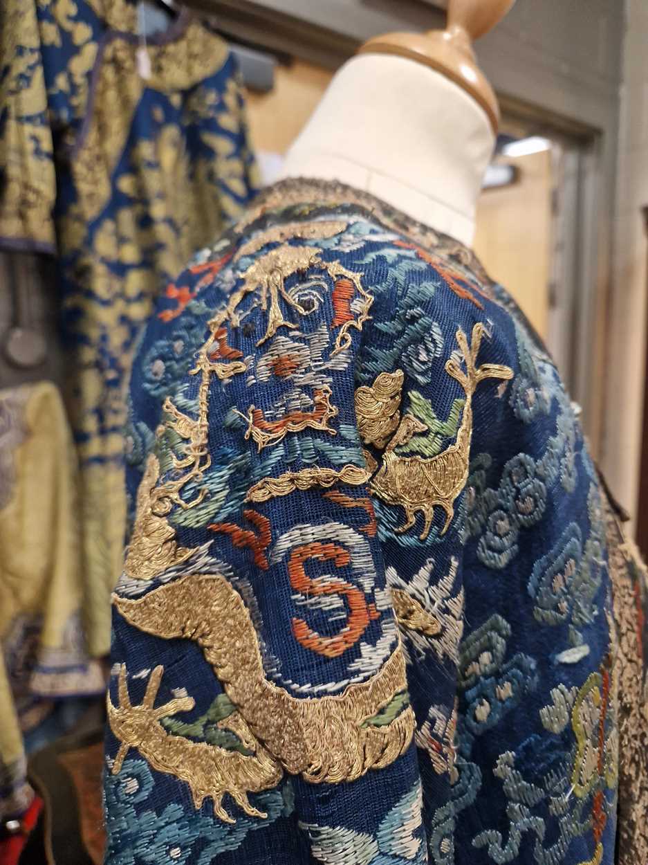 A Chinese embroidered silk blue ground dragon robe, late Qing Dynasty, - Image 16 of 18