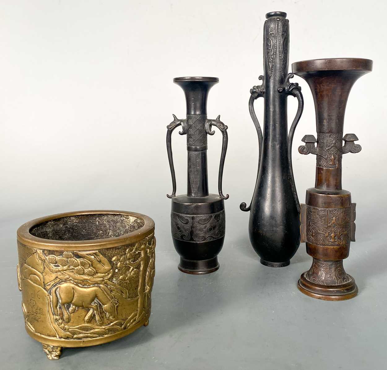 Three Chinese bronze small cylinder vases in an archaic style,