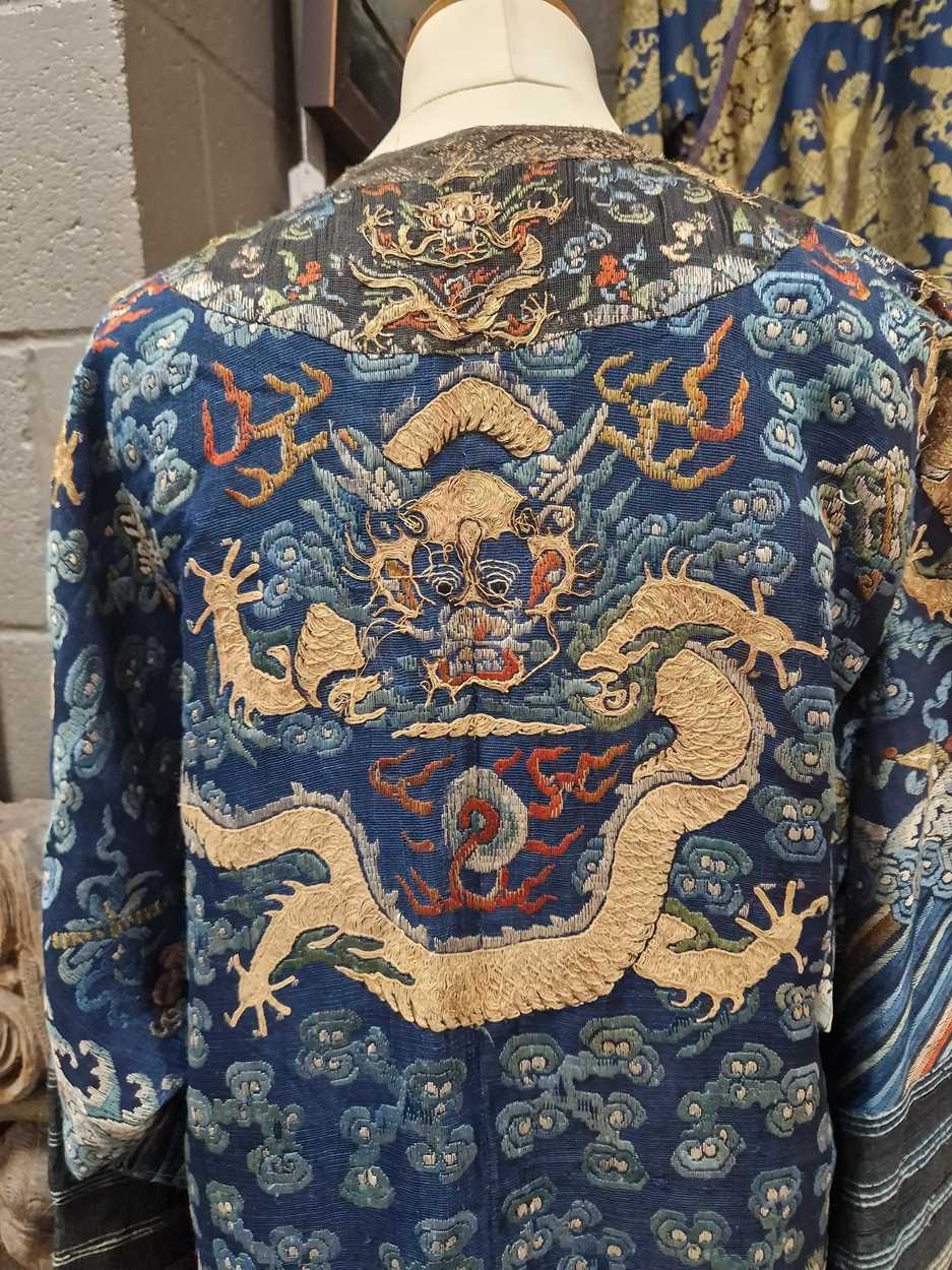 A Chinese embroidered silk blue ground dragon robe, late Qing Dynasty, - Image 11 of 18