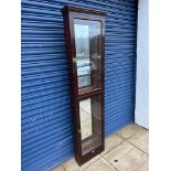 A tall Edwardian front opening two door display cabinet, with mirrored back and six glass shelves,