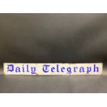 A Daily Telegraph narrow enamel strip sign, 30 x 3 1/2".