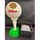 A large Wilson golf ball dispenser in the shape of a golf ball on a tee, 36" h plus a box of golf