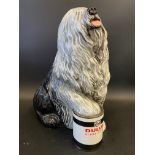 A Beswick Dulux dog, foot on tin model, 12 1/2" h.