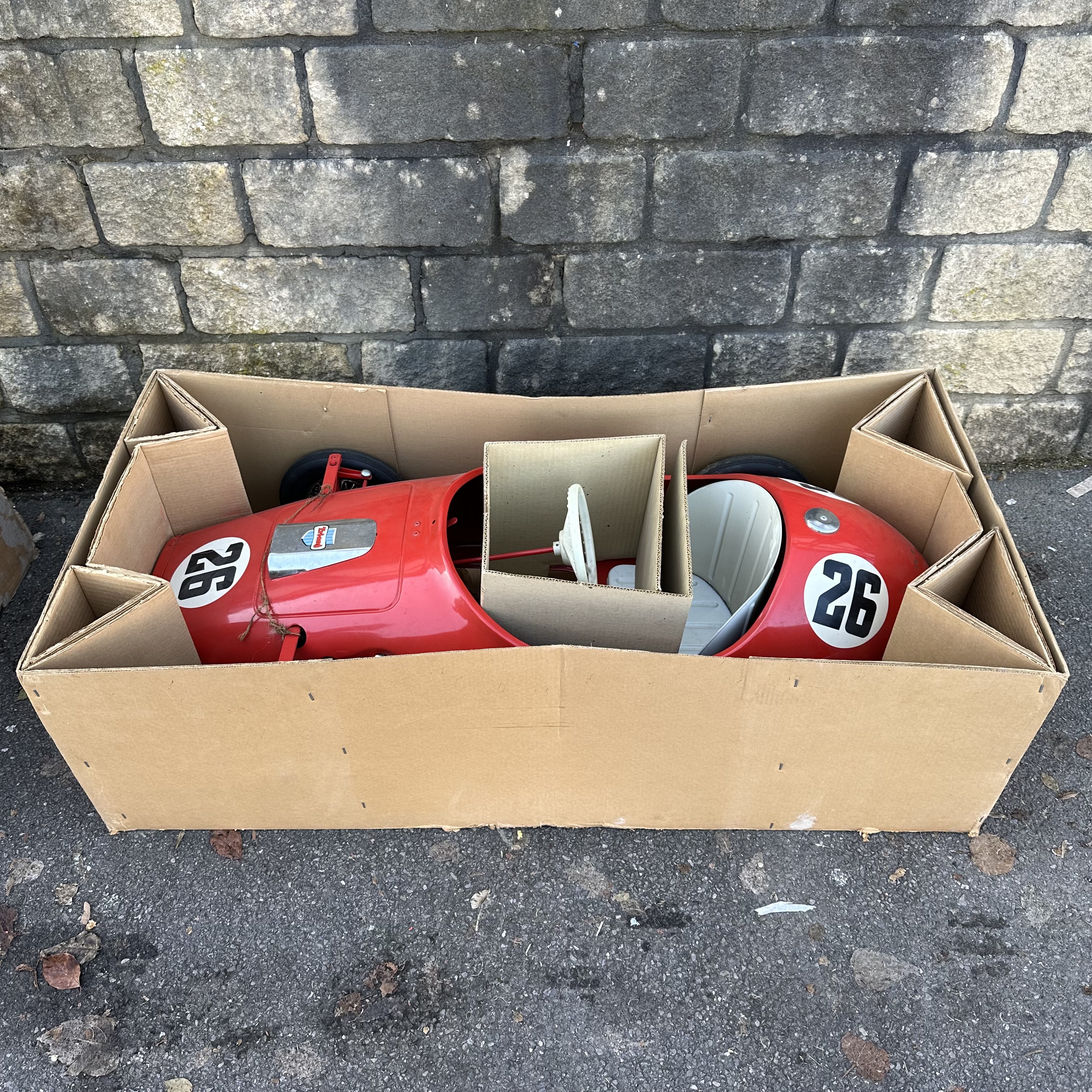 A Tri-ang Toys Grand Prix racing car in Ferrari Red, in original box with innards, approx 5ft