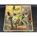 An Edwardian 'Magnetic Fish Pond' game by McLoughlin of New York, complete with board, fish counters