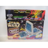 A boxed Star Wars electronic game made by Tiger and a Kenner boxed light sabre.