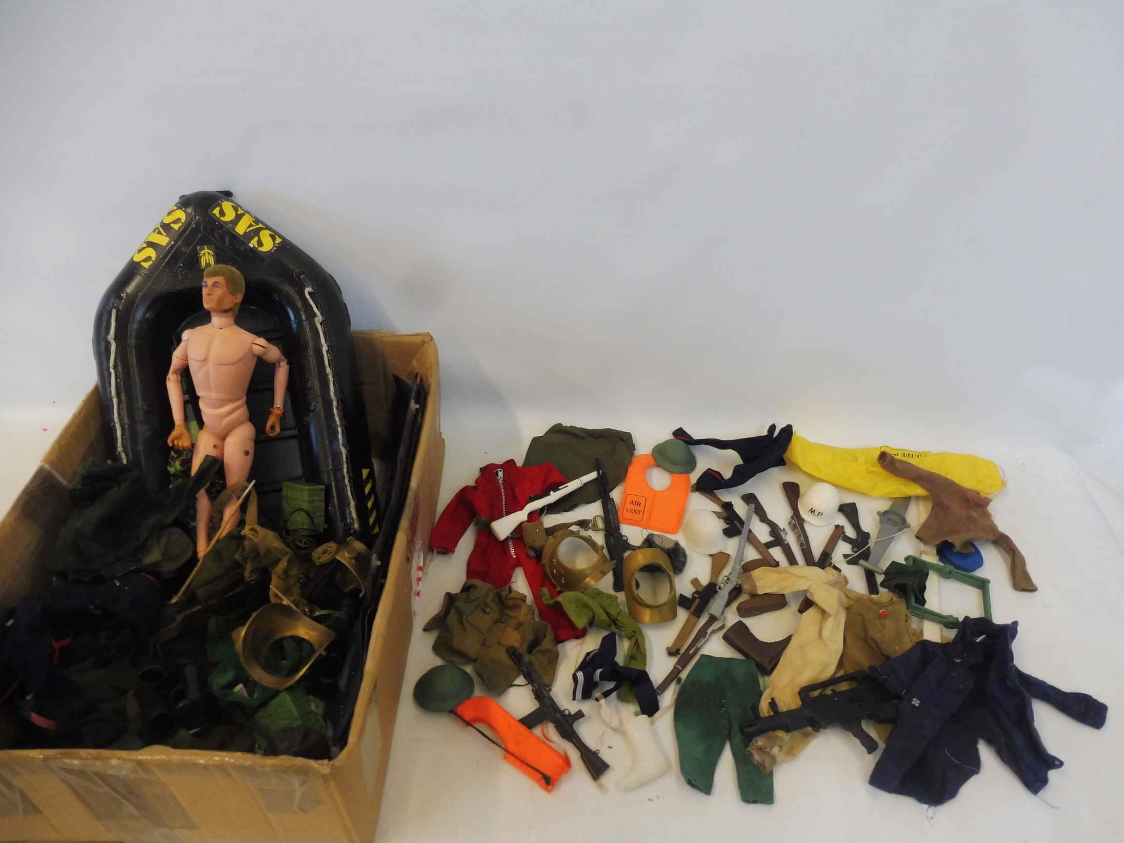 A large quantity of mixed era Action Man uniforms, guns, accessories etc.