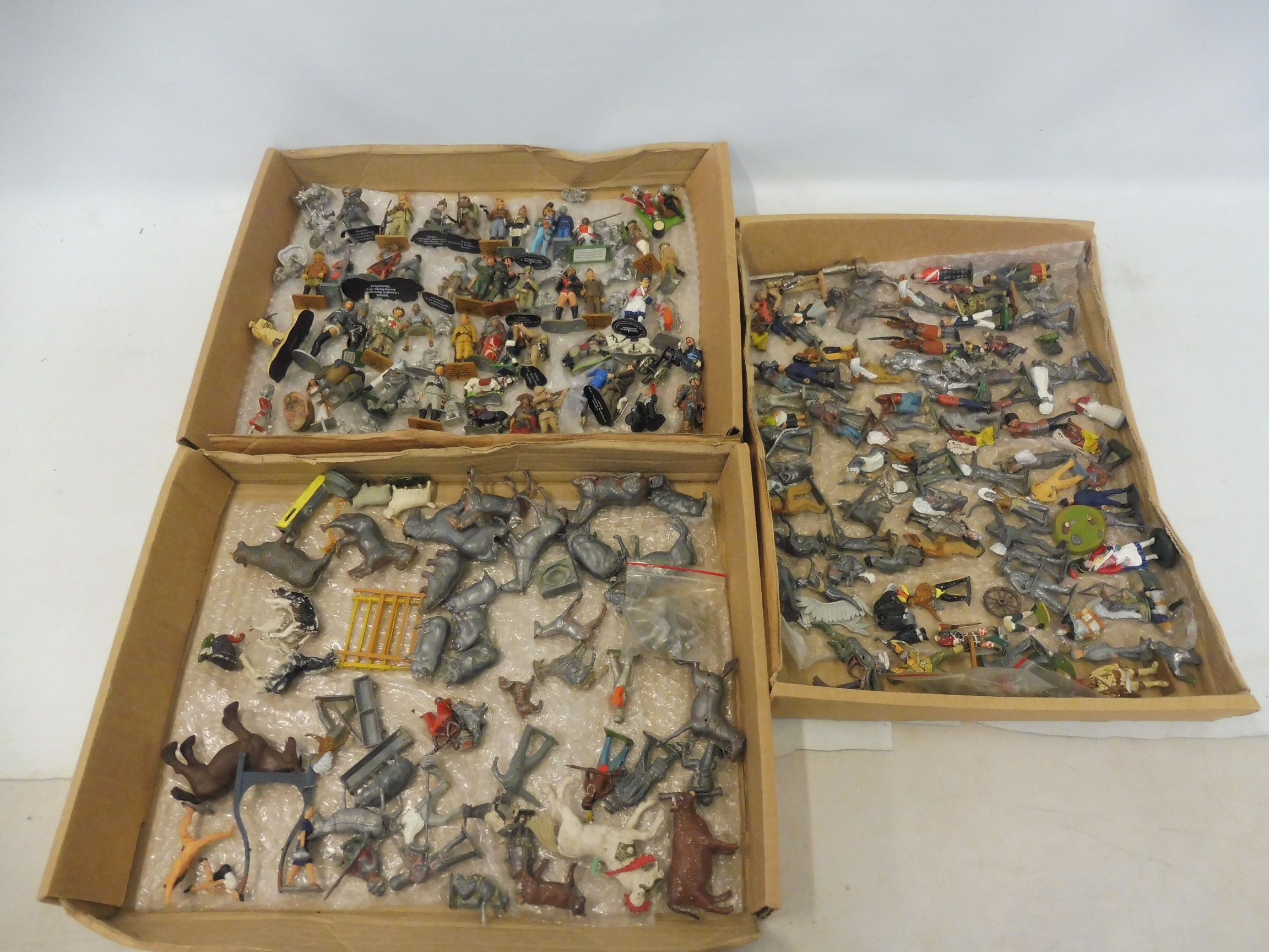 Three trays of assorted metal die-cast figures.