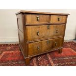 An 18th Century walnut and oak chest of two short over two long drawers, with panelled sides and