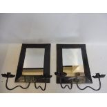 A pair of contemporary mirrored wall sconces with pie-crust detail drip trays.