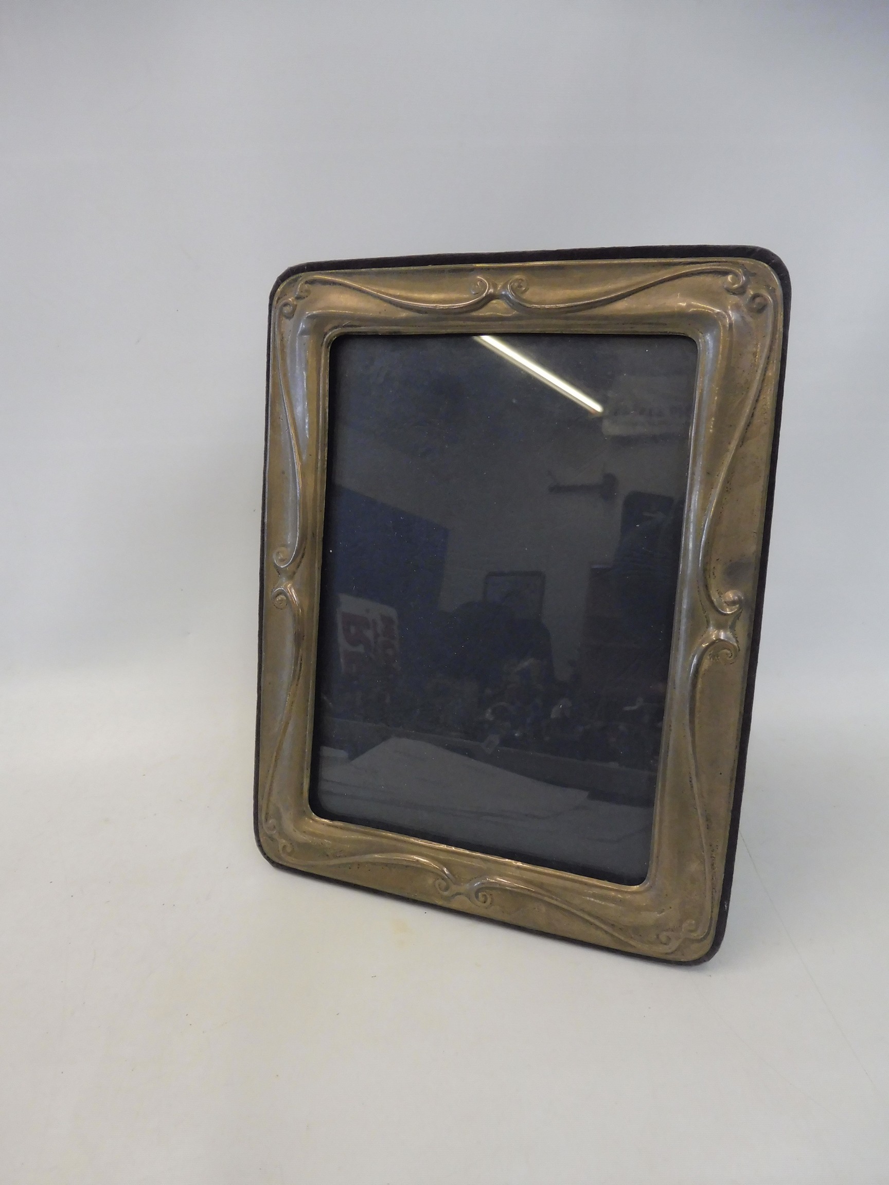 A silver photograph frame in the Art Nouveau style, maker K F Limited, London 1991.