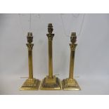 A pair of brass Corinthian column table lamps, height of column 10 1/2" and another 13".