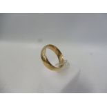 A 9ct gold wedding band, approx. 7.4g.