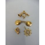Three 9ct gold charms - a ship's wheel and two bugles, approx 3.3g overall, plus a single 18ct