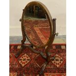 An Edwardian mahogany and boxwood strung oval dressing table mirror.