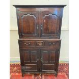 An 18th Century oak housekeeper's cupboard, the upper section with two arched panelled doors,