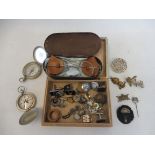 A quantity of assorted collectables to include military badges, cased glasses, compasses etc.