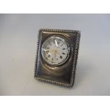 A small contemporary silver cased table clock.