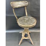 An Evertaut industrial stool with back, bearng label to stem.