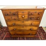 A late Victorian mahogany chest fitted with an arrangement of eight drawers on a plinth base, 46"