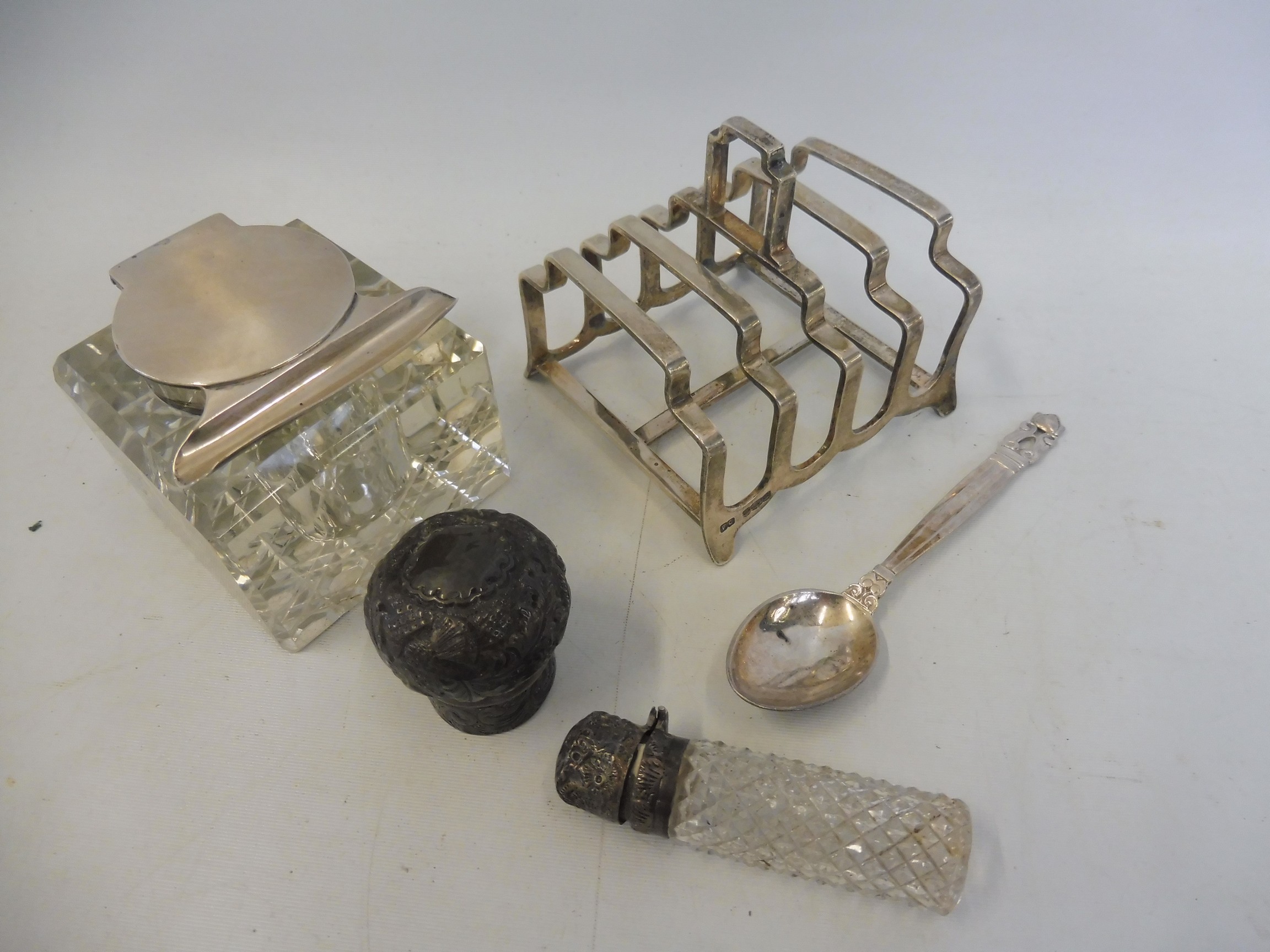 A silver five bar toast rack; a glass and silver mounted inkwell and silver items.