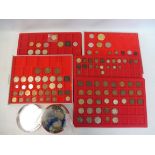 Five trays and a tin full of assorted coins, some old English includng a Florin, also some