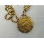 A yellow metal coin in the manner of a sovereign, on a yellow metal chain, hallmarked on the