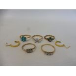 Five gold rings, one set with three small diamonds, another with turquoise and a pair of earrings,