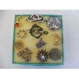 Eleven brooches including Celtic designs, filligree etc.