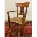 A Continental fruitwood rush seated carver chair with carved and pierced splat, 33" high.
