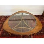 An 'astro' teak coffee table inset glass top.