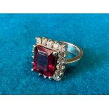 A tourmaline and diamond ring - one large red emerald cut tourmaline (12.00mm x 10.23mm x 6.8mm)