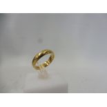 An 18ct gold wedding band, approx. 3.9g, size M/N.