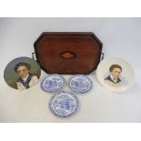 A small Edwardian mahogany tray inlaid with a shell, 19" wide; a pair of circular porcelain plates