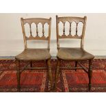 A pair of 19th Century elm seated kitchen chairs with mixed wood backs.
