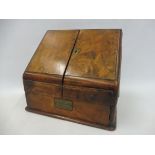 A late Victorian walnut sloping fronted stationery cabinet.