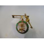 An unusual green enamel and yellow metal pendant, mounting loop indistinctly hallmarked, appears