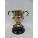 A silver two handled trophy titled The Burdett Challenge Cup, made by Elkington & Co. Birmingham