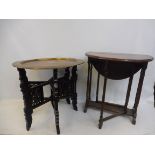 A small oak drop flap table and a good quality brass topped table with folding carved wooden base.