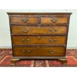 A George III oak and mahogany crossbanded chest of two short over three long drawers raised upon