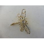 A 9ct gold dragonfly brooch, set with two small diamonds and a pale blue stone, approx. 3.3g.