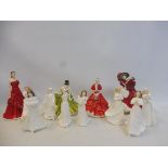 Four large Royal Doulton figurines including 'A Gift for Christmas' plus eight smaller Royal Doulton
