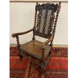 A 19th Century walnut armchair with carved and barleytwist features, a cane back and a cane seat, 44