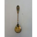 A Continental silver gilt spoon with an enamel handle, stamped .925 S.