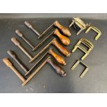 A selection of wind-out dining table handles and various brass clips for securing additional table