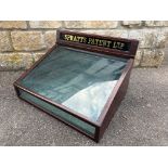 A Spratt's Patent Ltd counter top mahogany dispensing cabinet with rear opening door and glass